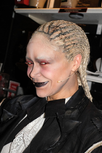 Image may contain Hair Person Adult Braid Clothing Coat Face and Head